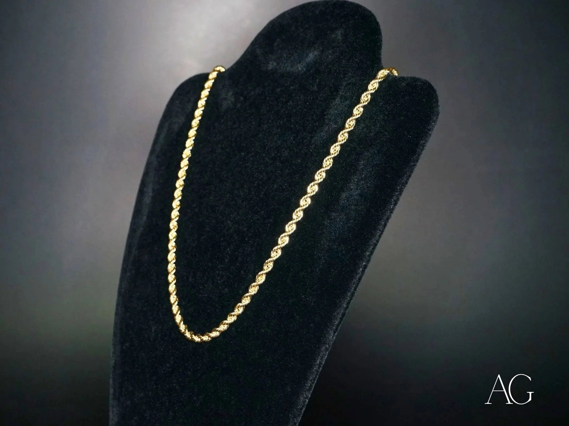 Gold rope chain necklace on black velvet stand showcasing solid 14k gold elegance