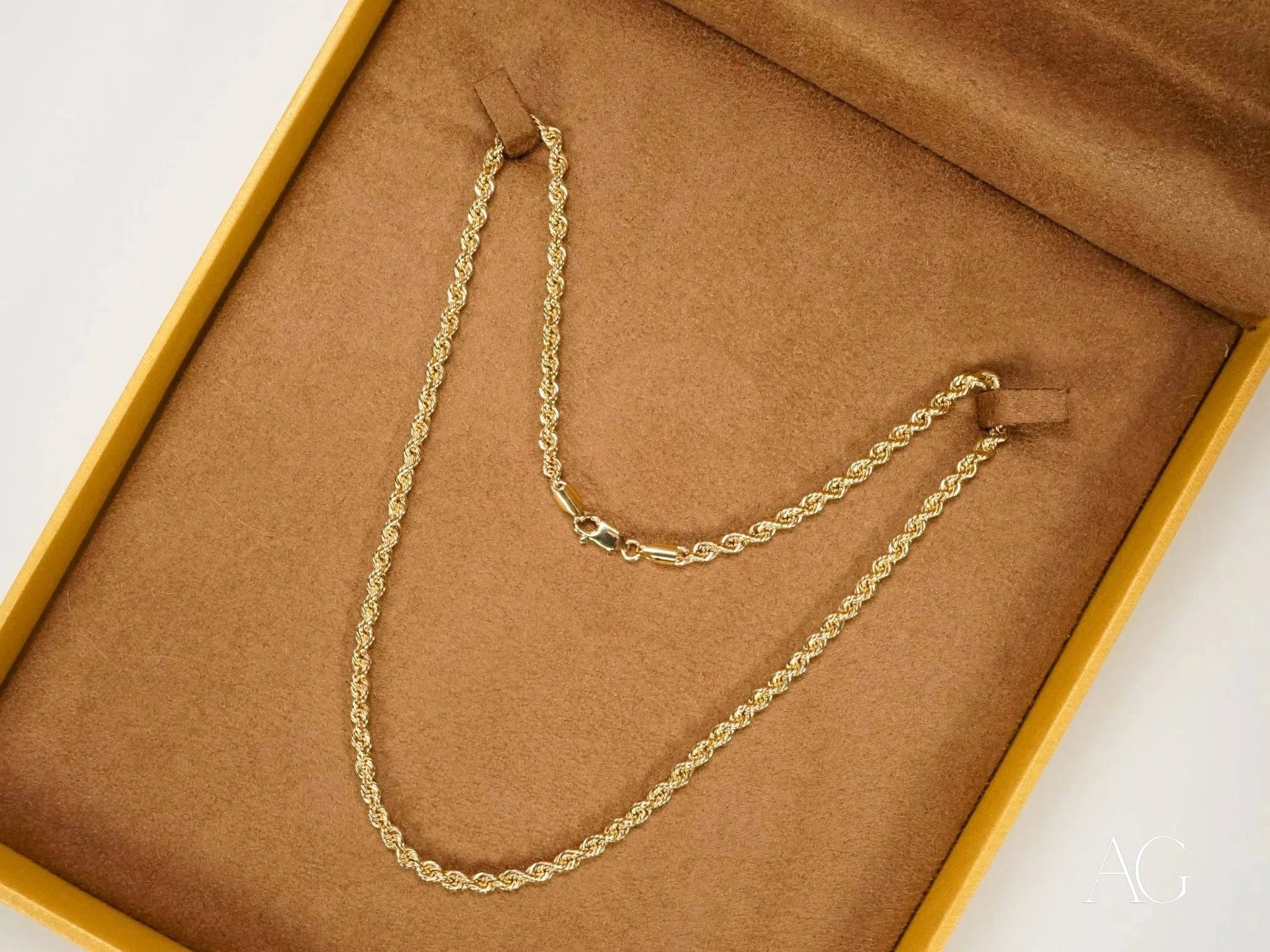 Gold rope chain necklace in a jewelry box, showcasing solid 14k gold elegance