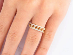 Delicate stacked 18k yellow gold rings showcasing timeless elegance and beauty