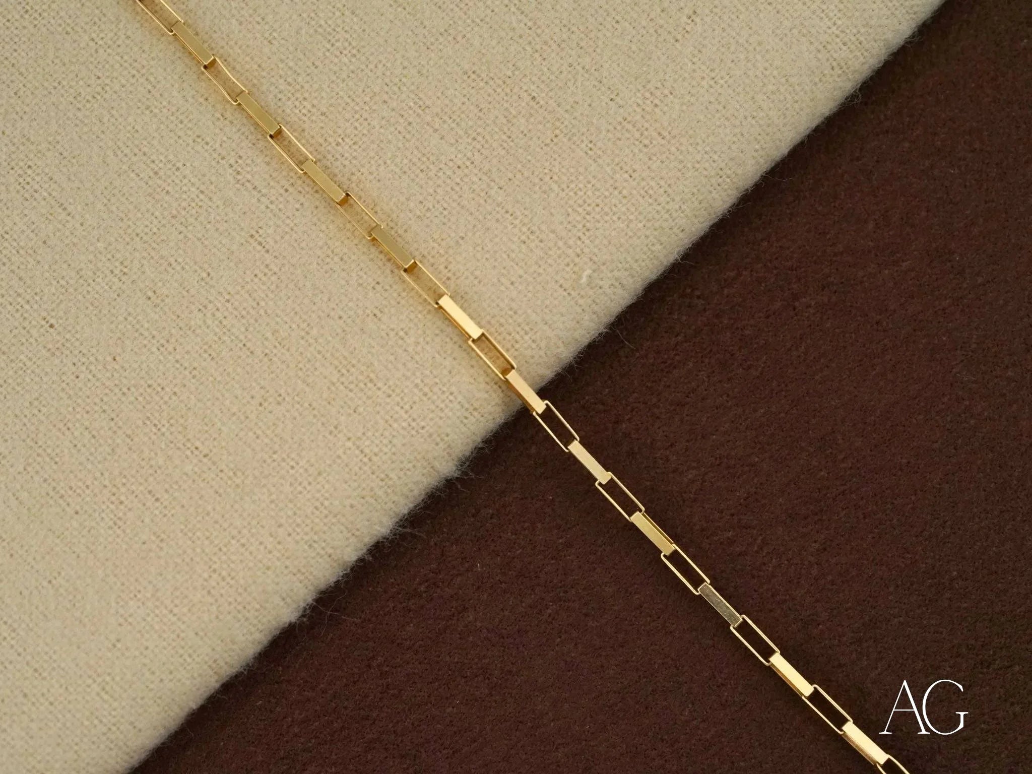 Delicate gold chain necklace featuring elongated rectangular links in solid 18k gold