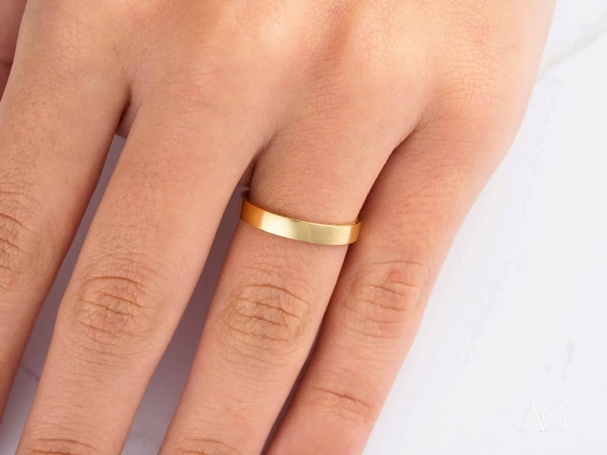 Gold wedding band on finger showcasing Timeless 18k yellow gold craftsmanship