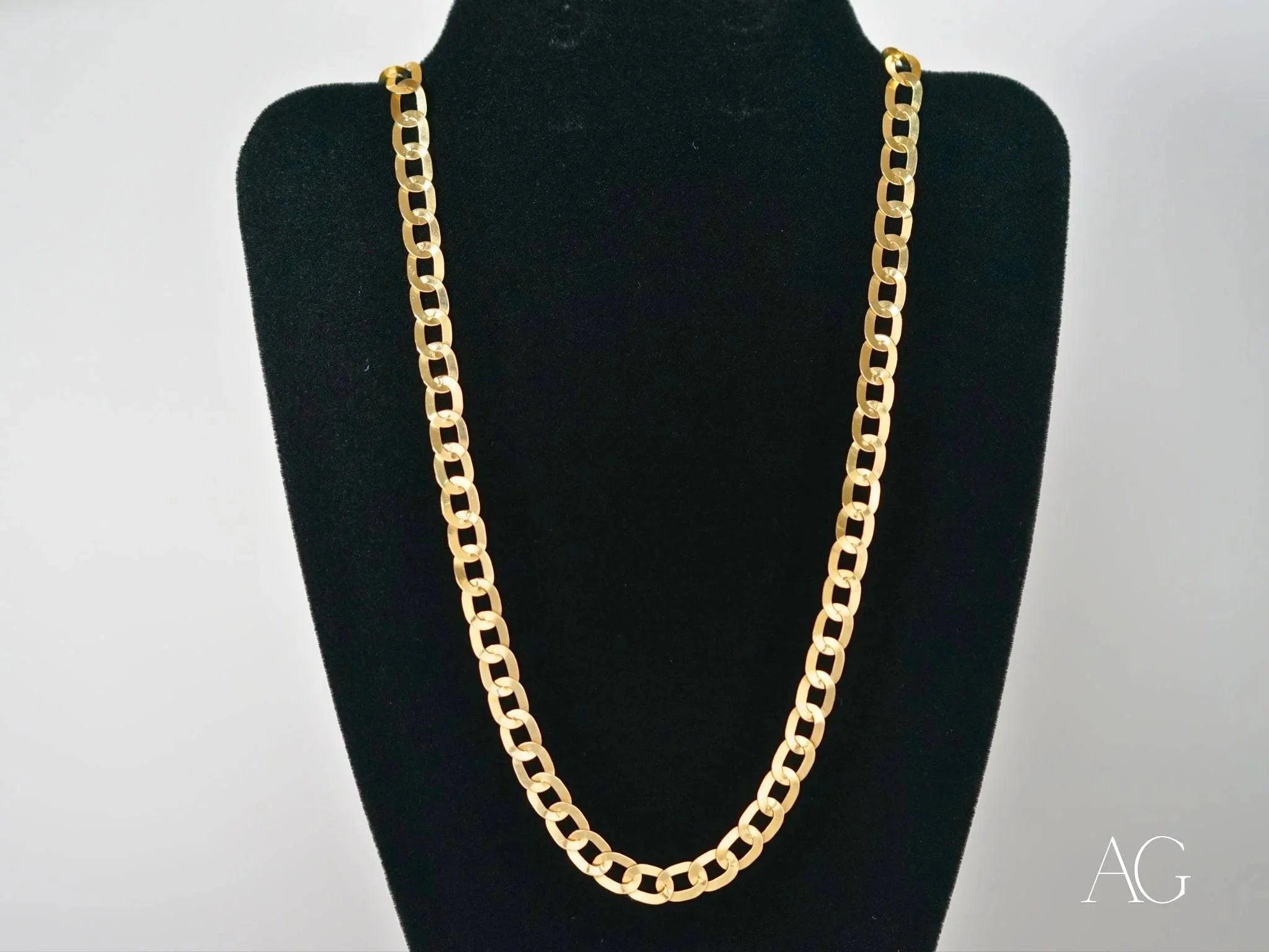 Gold chain necklace on black display stand showcasing the Timeless Love flat oval link design