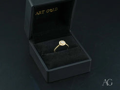 Twist of Grace Engagement Ring featuring center diamond in black jewelry box with 18k gold