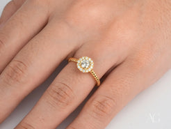 Twist of Grace Engagement Ring in 18k gold with a center diamond cluster on textured band