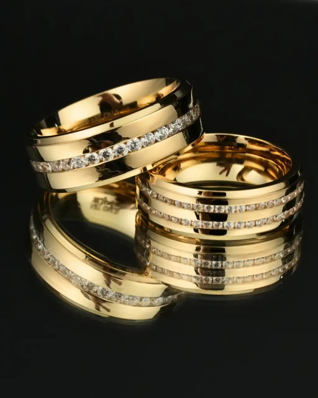 Two gold wedding bands with diamond channel inlays.