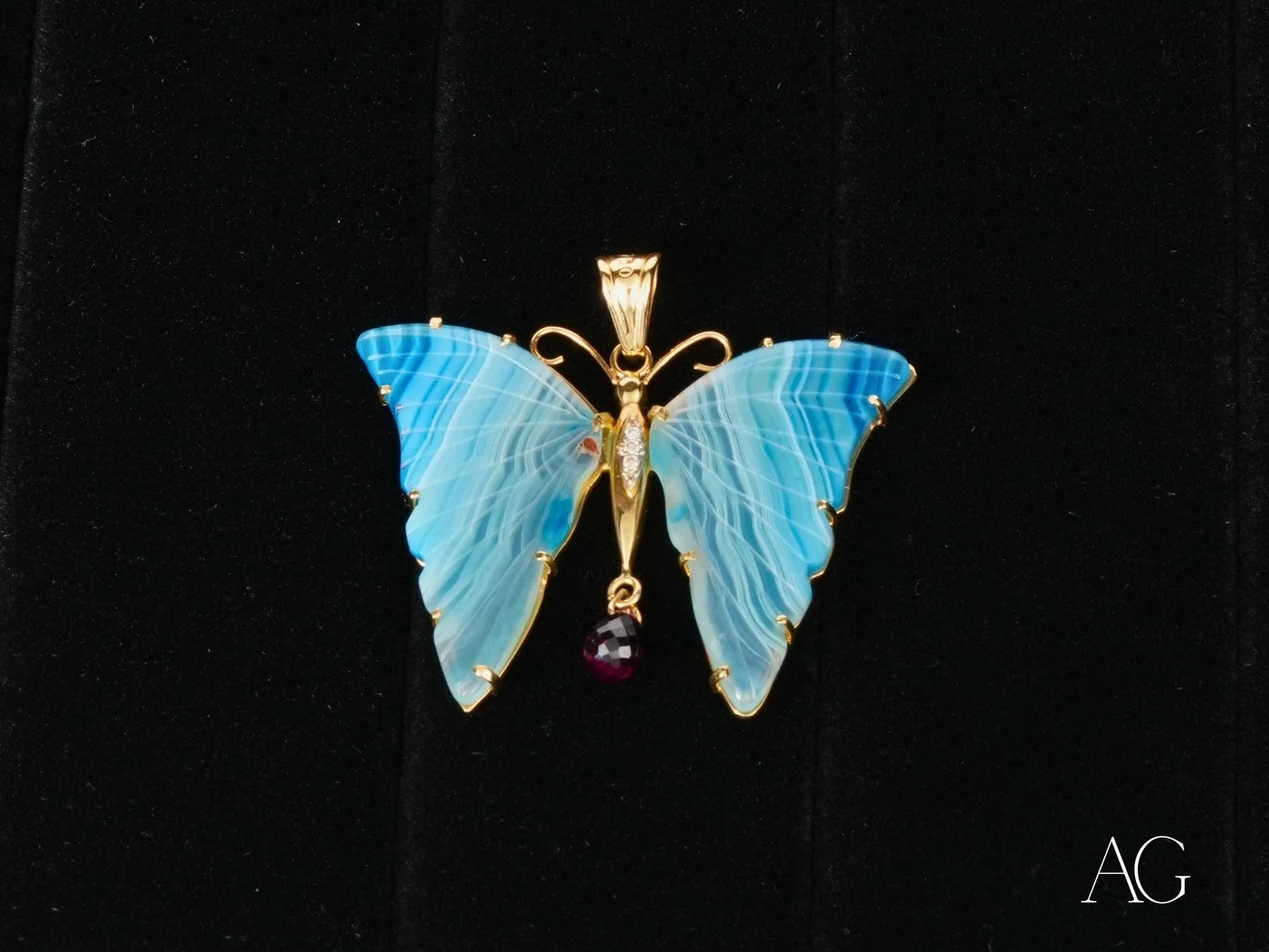 Delicate turquoise butterfly pendant with 18k yellow gold trim and purple crystal drop