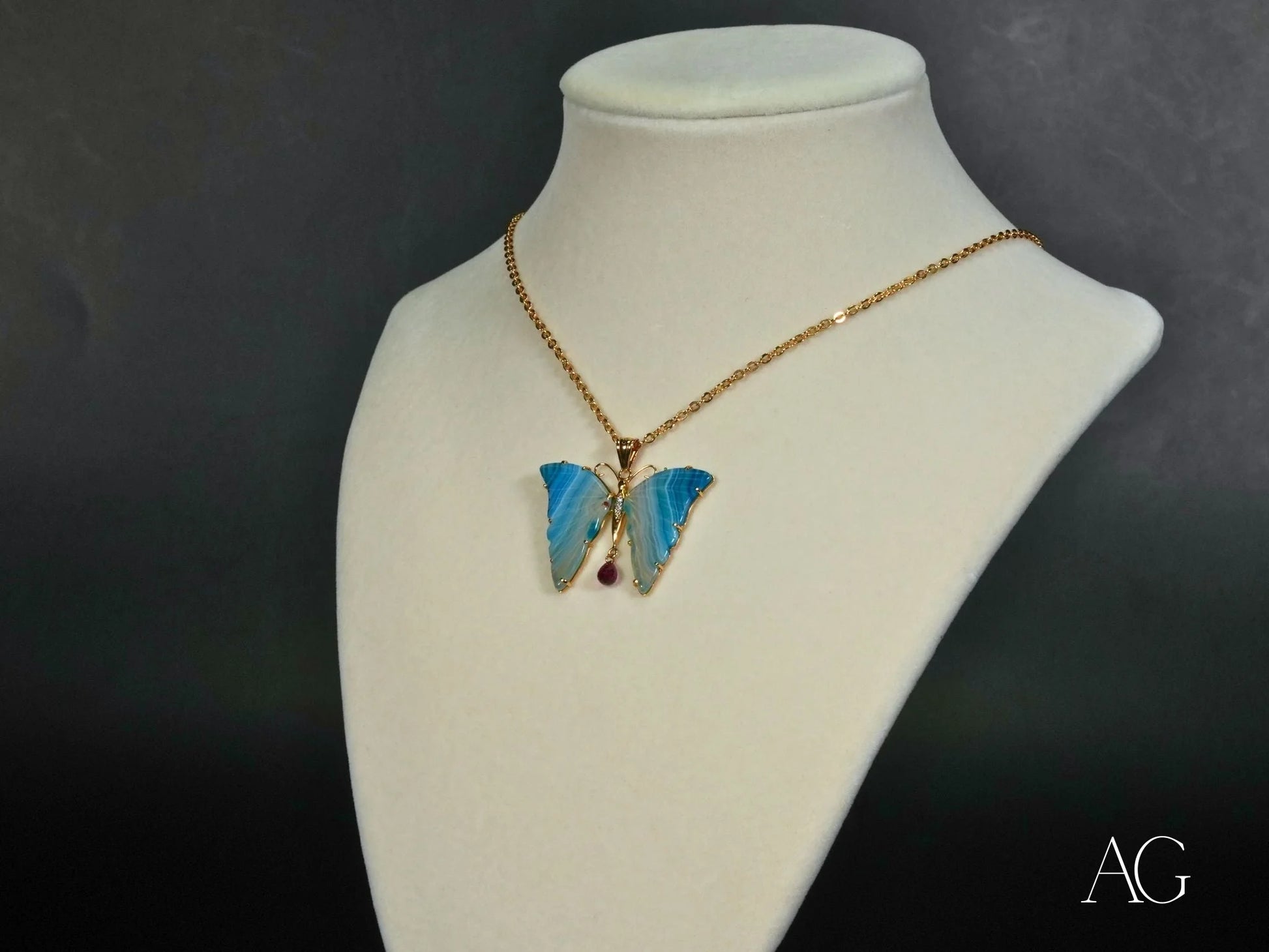 Gold chain necklace in 18k yellow gold featuring a butterfly pendant with gemstones