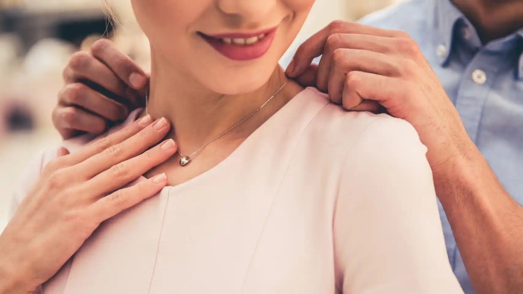 Woman receiving necklace.