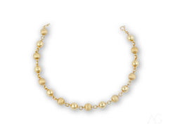 Women’s 18k solid gold bracelet with spring ring clasp and golden-hued pearl necklace