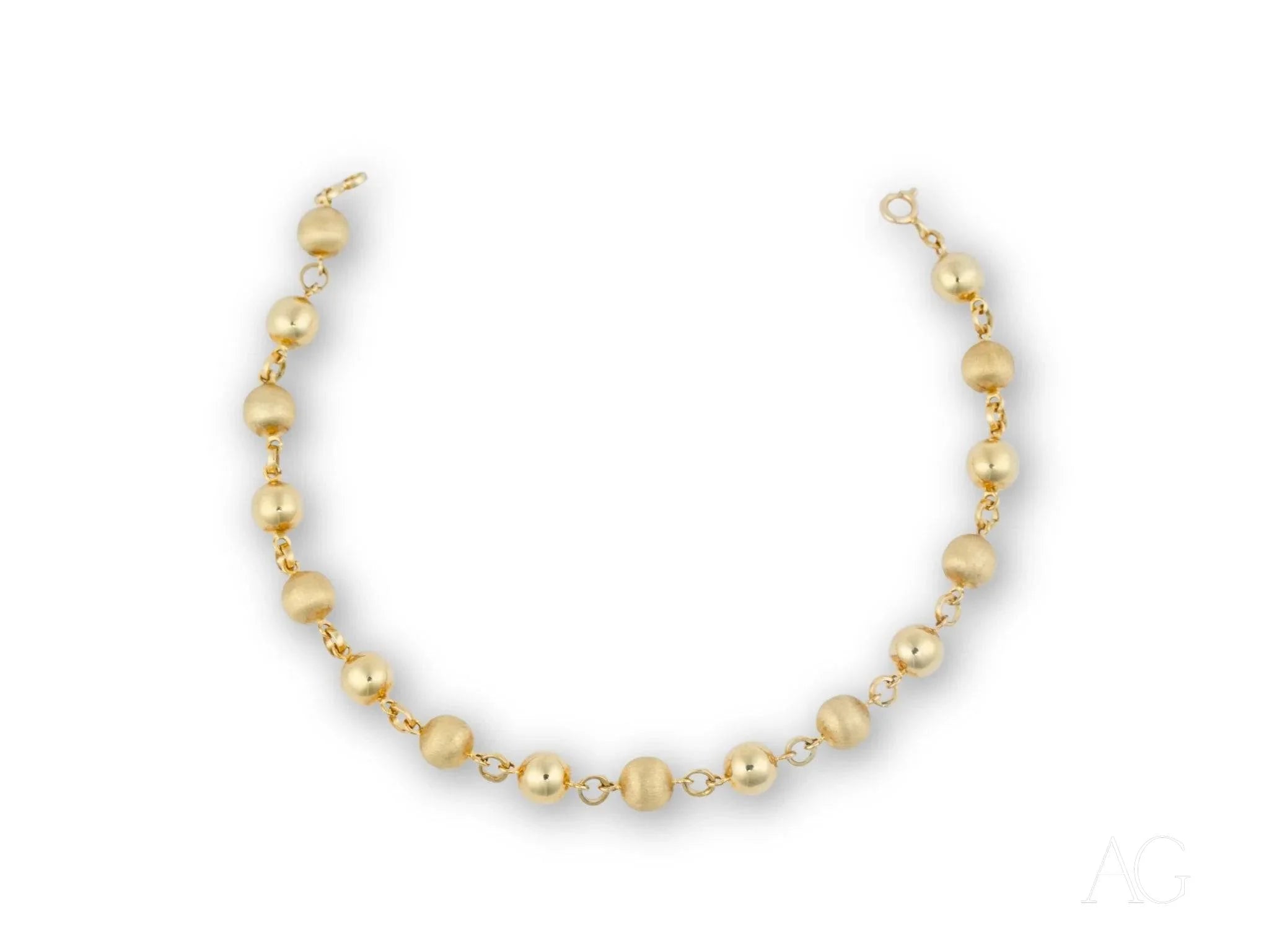 Women’s 18k solid gold bracelet with spring ring clasp and golden-hued pearl necklace